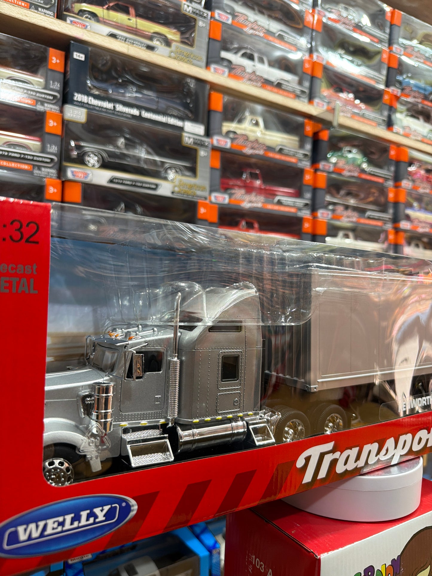 Welly Kenworth KW900 Escala 1:32 Gris con Tráiler Plateado